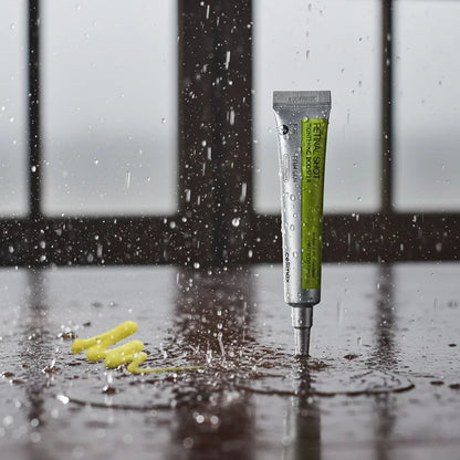 Celimax Retinal Shot Tightening Booster anti-aging serum in a precision applicator tube displayed with water droplets, highlighting its skincare formula for improving skin firmness, reducing fine lines, and enhancing skin texture.